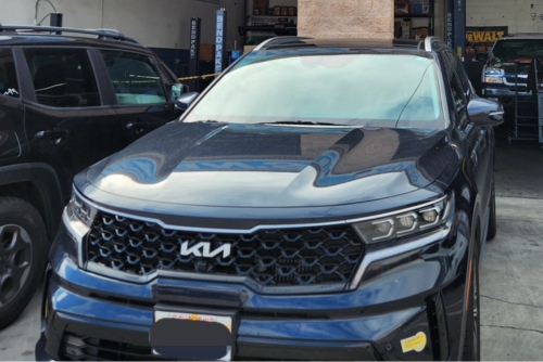 Hybrid repair and maintenance in Los Angeles and Van Nuys, CA with Sean’s Auto Care. Image of a KIA hybrid car parked at the garage of Sean’s Auto Care after undergoing hybrid car maintenance.
