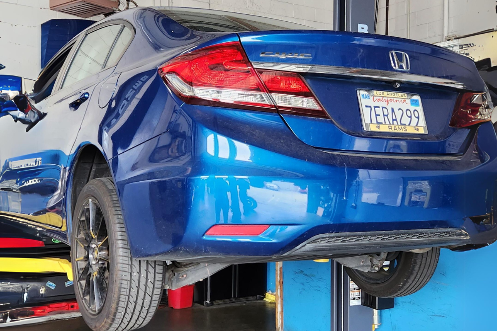 Honda auto repair in Van Nuys, CA by Sean’s Auto Care. Image of a blue Honda Civic on a lift in a professional auto repair shop, showcasing the expert maintenance and repair services provided to ensure optimal performance and longevity of Honda vehicles.