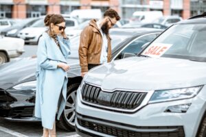 Top Used Cars and SUVs for Suburban LA: Your Guide to Smart Buying. A couple inspecting vehicles for sale in a dealership lot, highlighting the process of browsing and selecting a car.