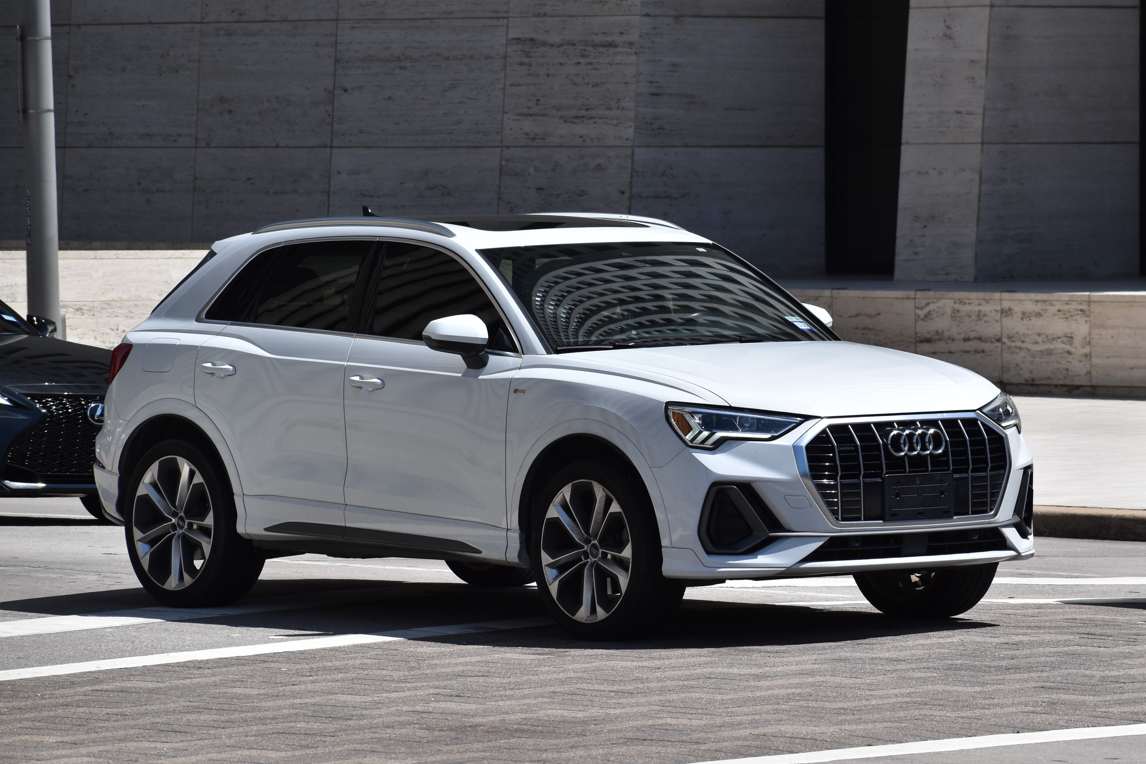 Audi Repair and Maintenance Specialists in Van Nuys, CA with Sean's Auto Care. Image of white Audi SUV parked sideways in a parking lot.