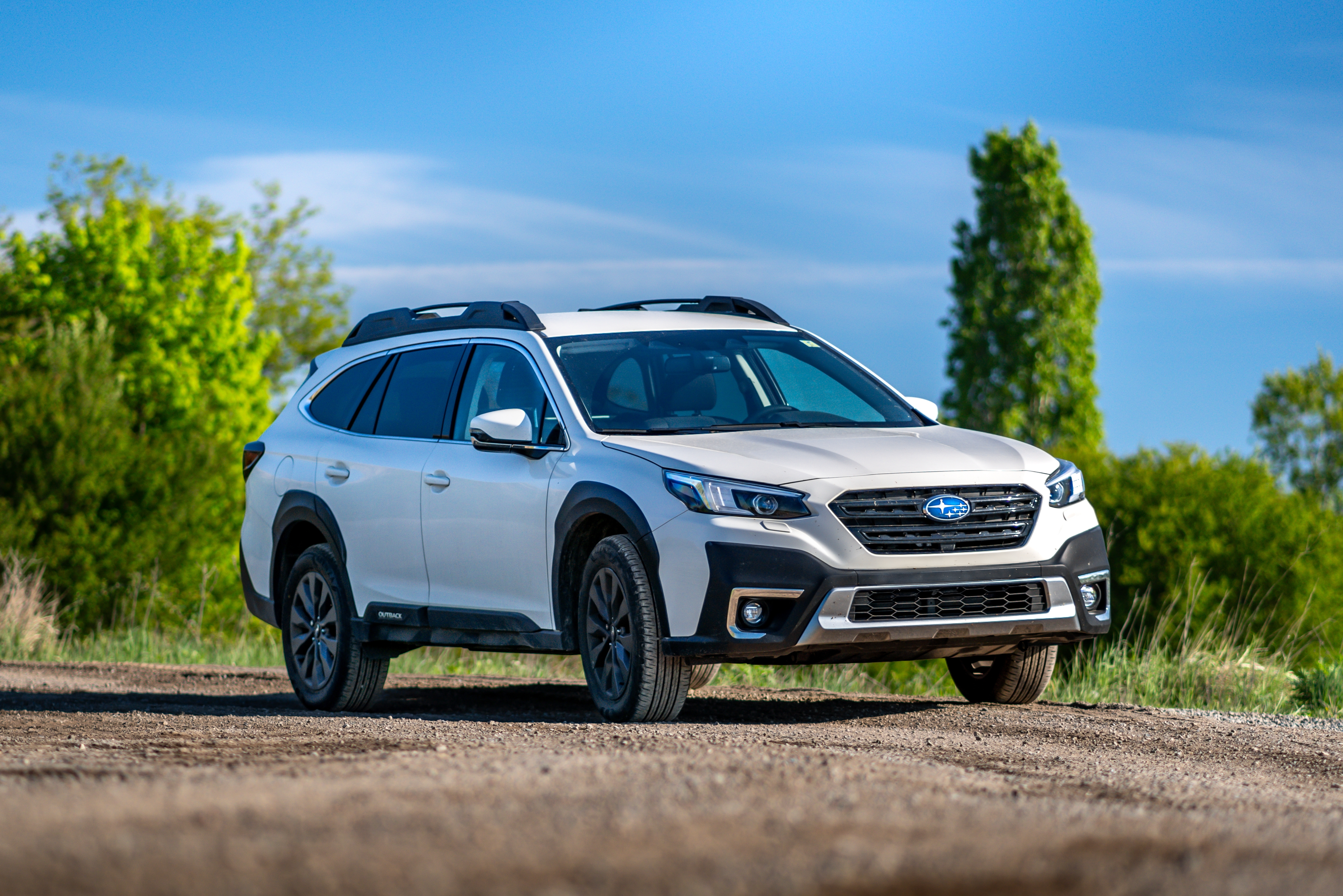 Subaru Repair and Maintenance in Van Nuys, CA with Sean's Auto Care. Image of white subaru outback parked on a mountainside landscape.