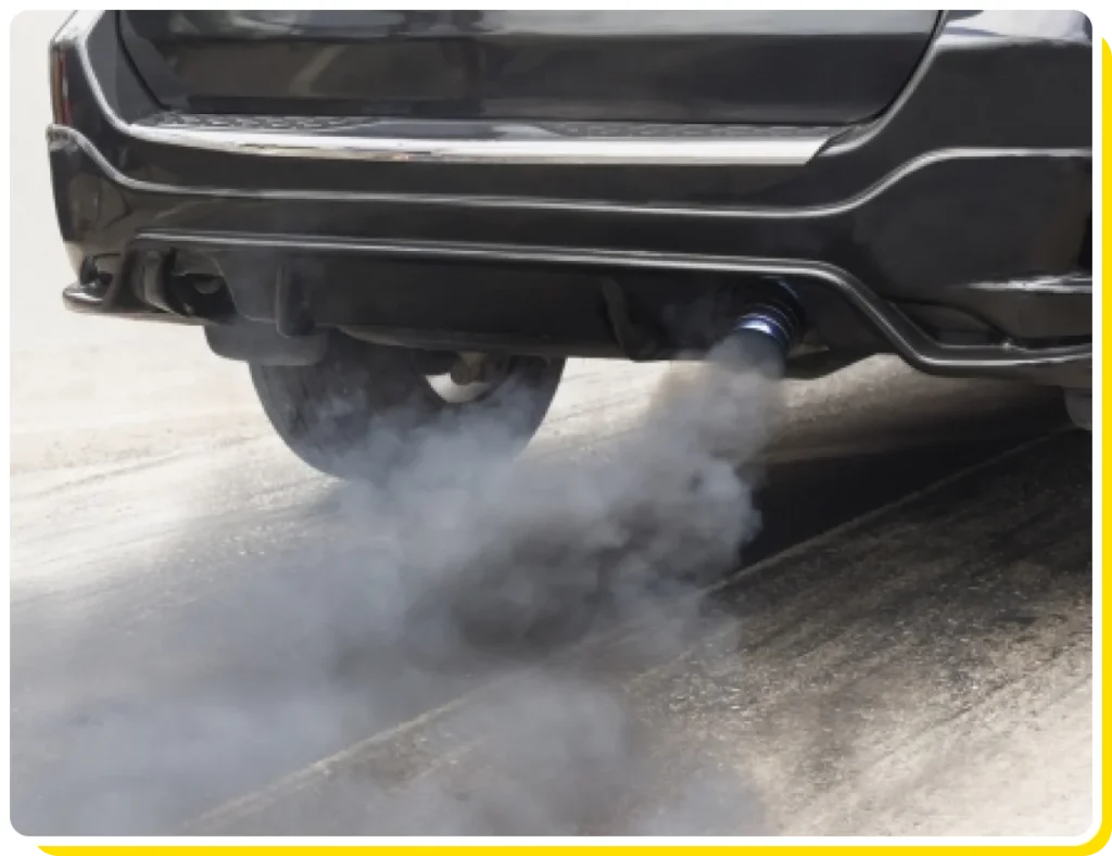 Emission system check service near me in Los Angeles and Van Nuys, CA with Sean’s Auto Care. Image of a black car emitting smoke from its exhaust pipe, indicating a potential emissions system issue.