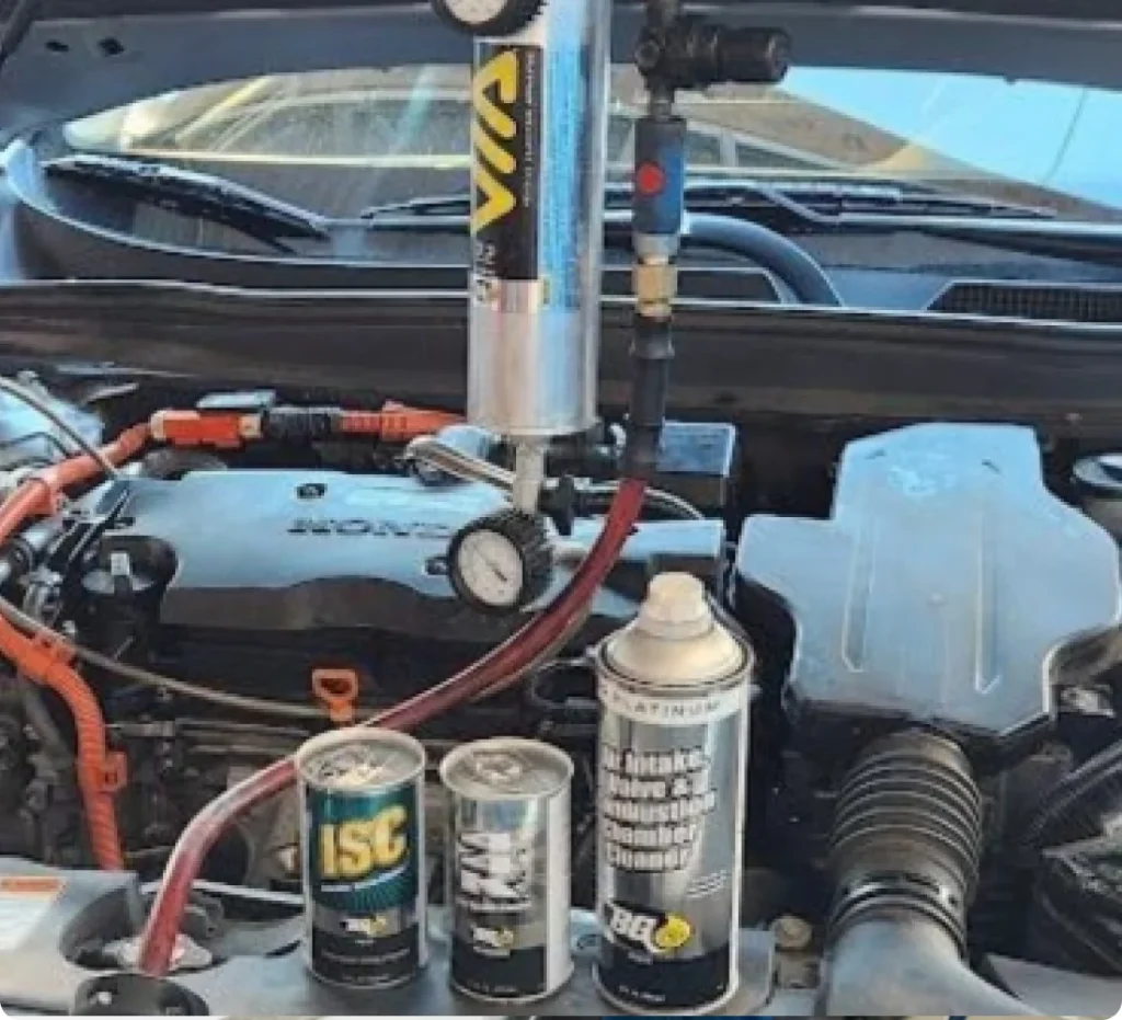 Fuel system service near me in Los Angeles and Van Nuys, CA with Sean’s Auto Care. Image of a Honda with its hood open, displaying the engine and products used for fuel system service.