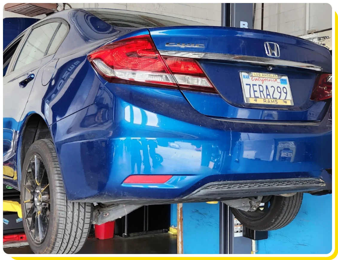 Honda auto repair in Van Nuys, CA by Sean’s Auto Care. Image of a blue Honda Civic on a lift in a professional auto repair shop, showcasing the expert maintenance and repair services provided to ensure optimal performance and longevity of Honda vehicles.