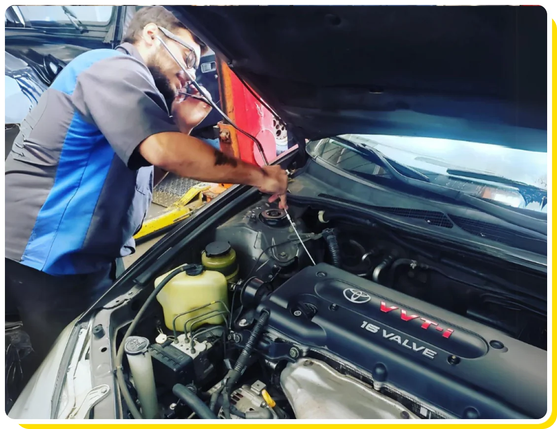 Toyota Auto Repair in Van Nuys and Los Angeles, CA with Sean's Auto Care. Image of mechanic using tools to clean off toyota car engine in shop